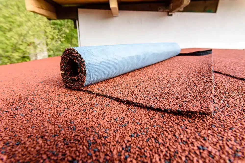 A view of a half unrolled orange granulated roll for roofing