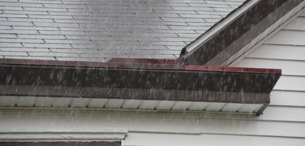 A view of a house roof in rain showers