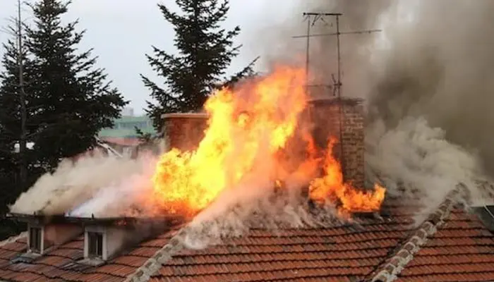 A view of a house roof on fire