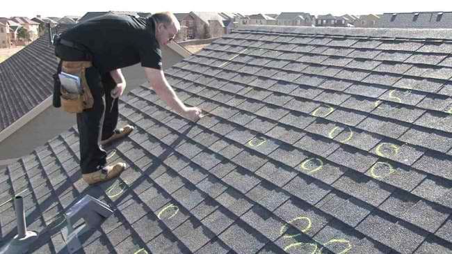 A view of a person marking the roof with a chalk