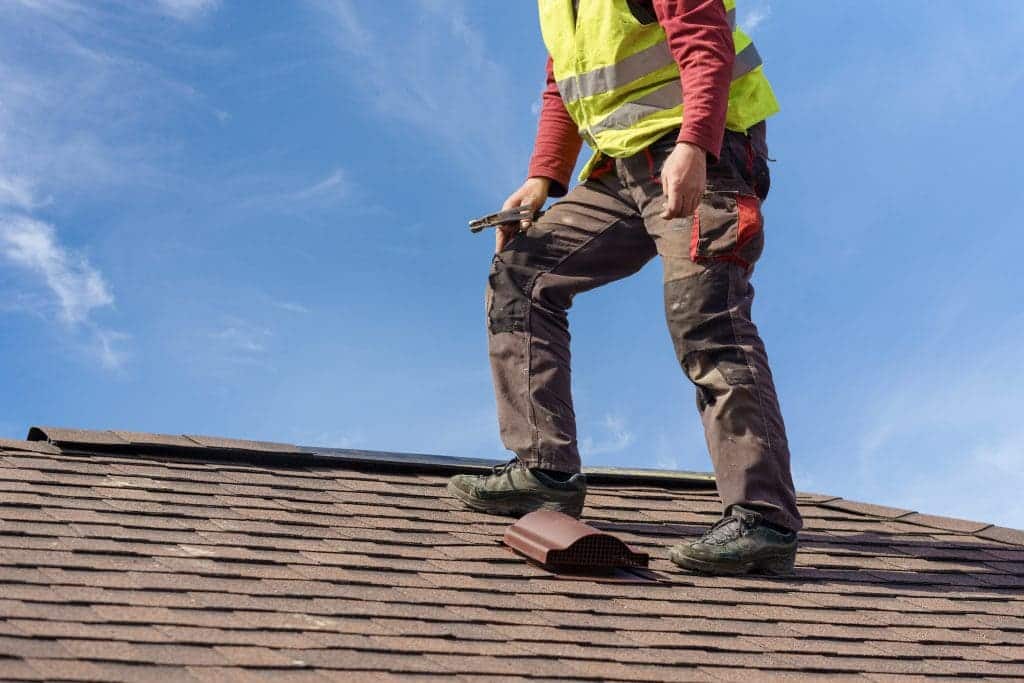 A view of a person standing on a house roof