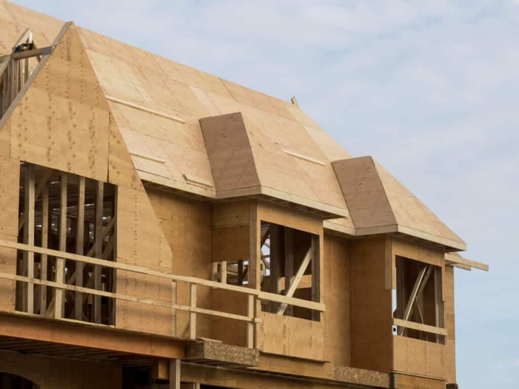 A view of a wooden house with wood roof top sheathing