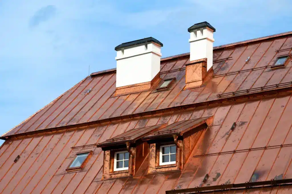 Close up of a copper roof against blue sky