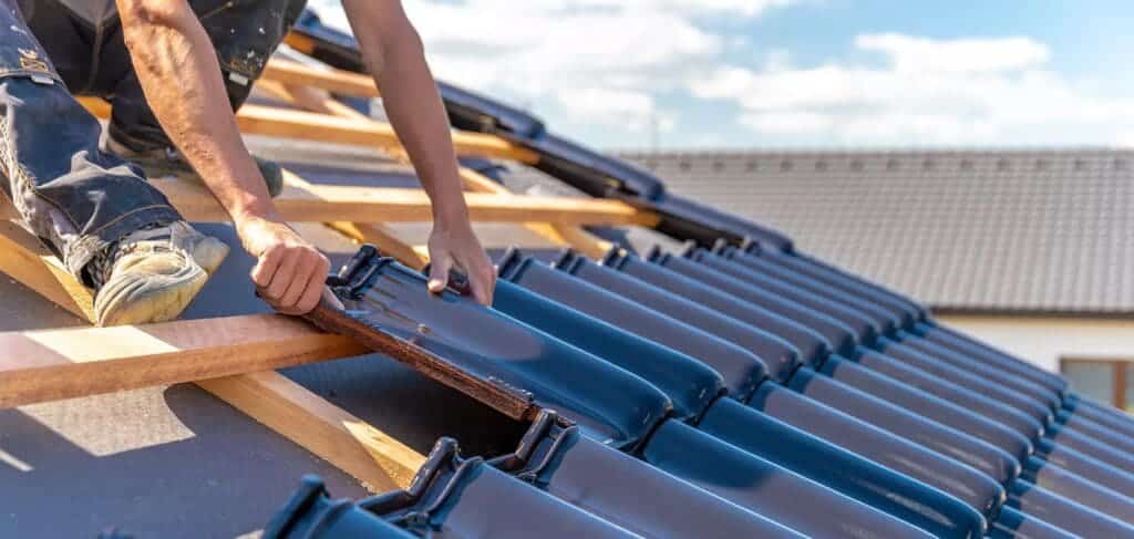 zoomed in view of male hands working with shed roofing