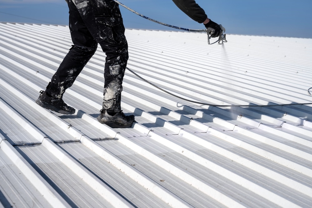 Metal Roof Painting Technician Performing Painting Of Roof In White color