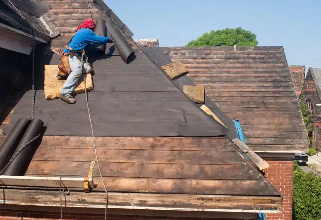 view of a persons back working with a roof repair jpg