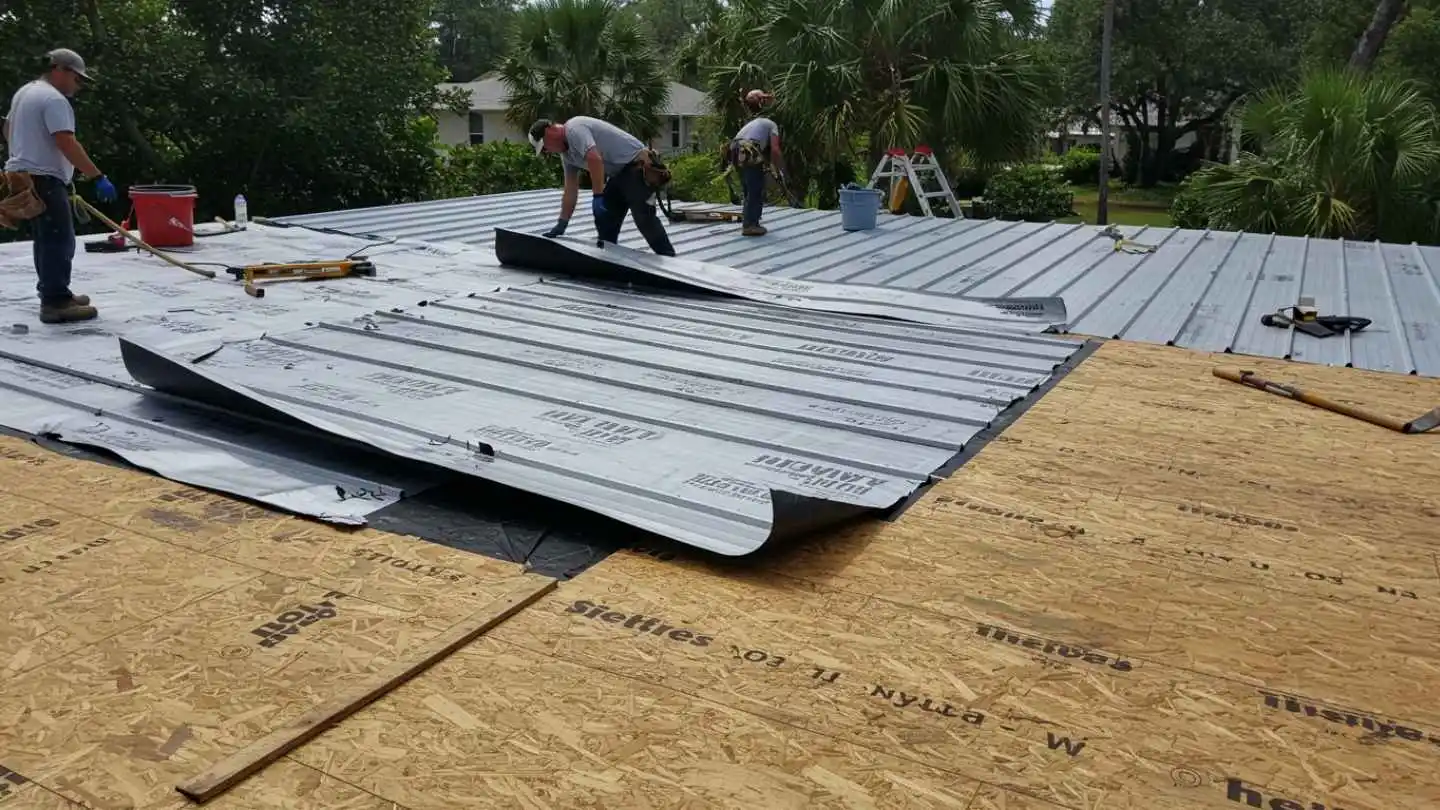 a number of underlayment sheets being installed by expert roofers a number of underlayment sheets being installed by expert roofers