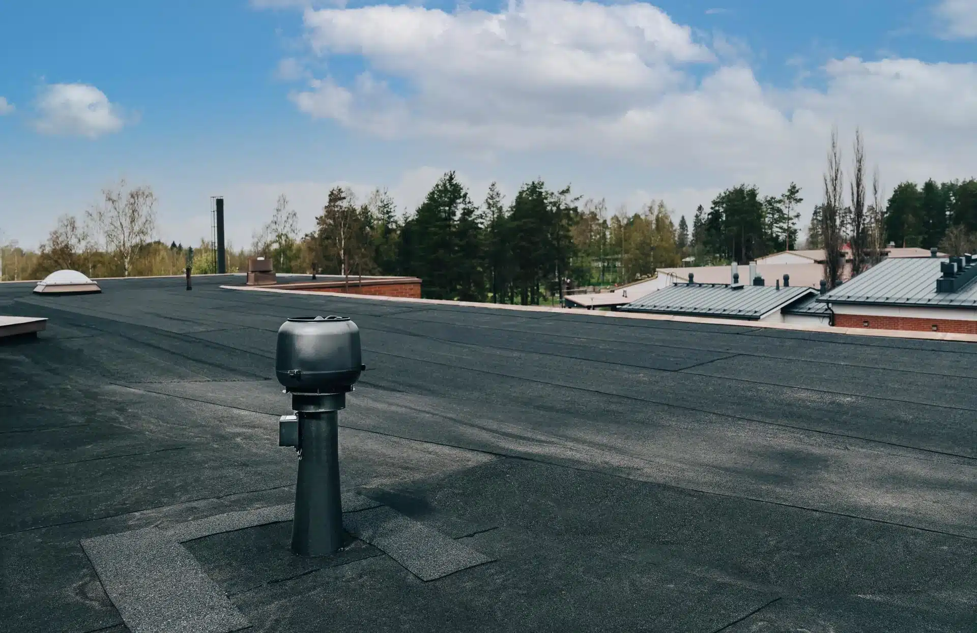 Flat roof with ventilation equipment and clear skies