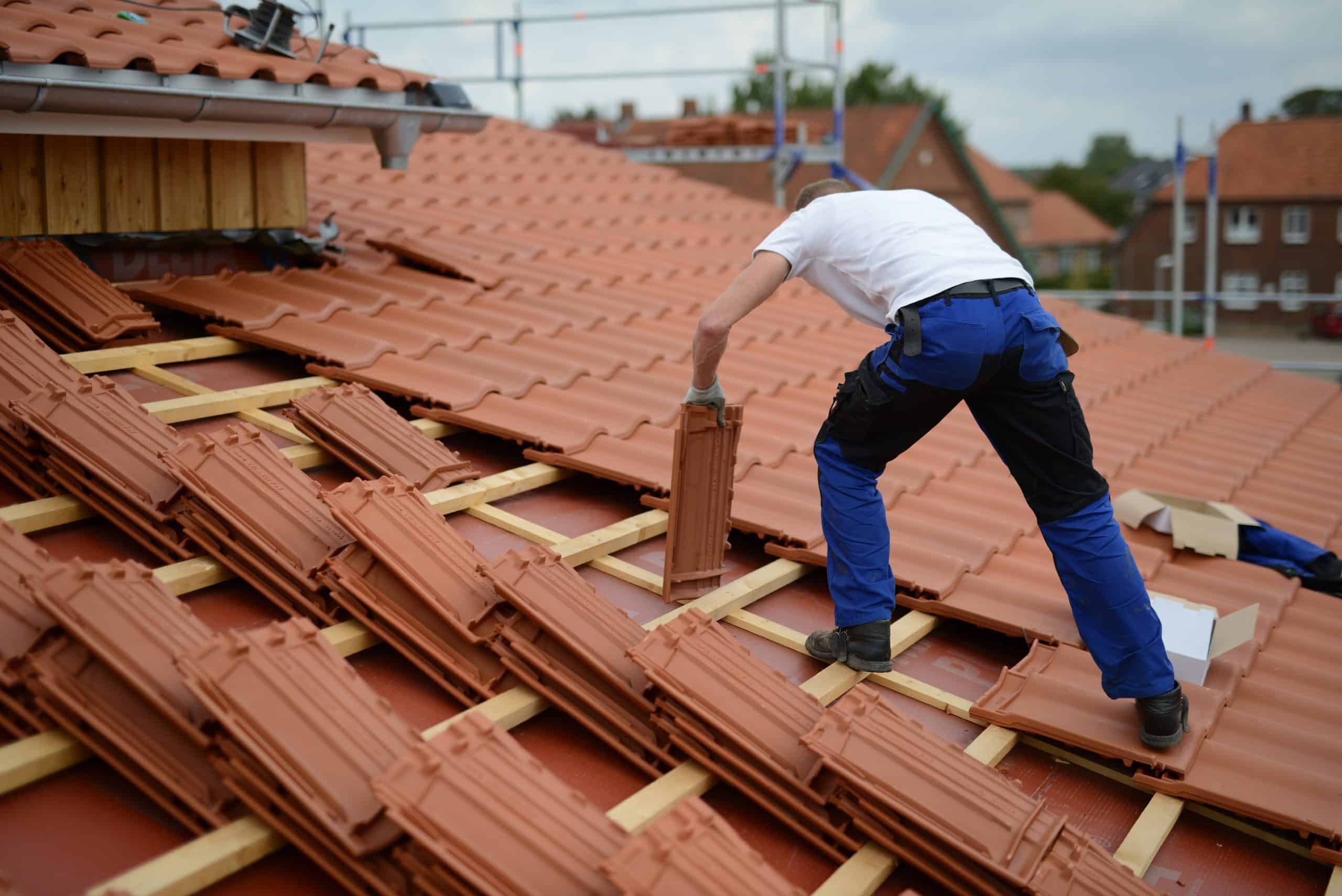 a person installing clay tiles with precision