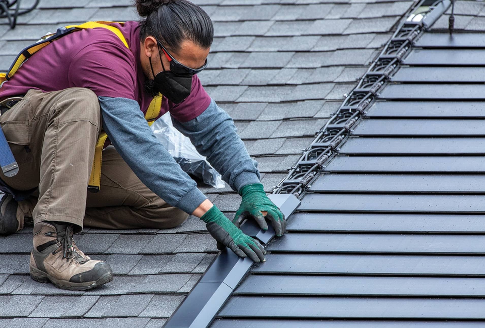 a pro roofer installing metal tiles on roof