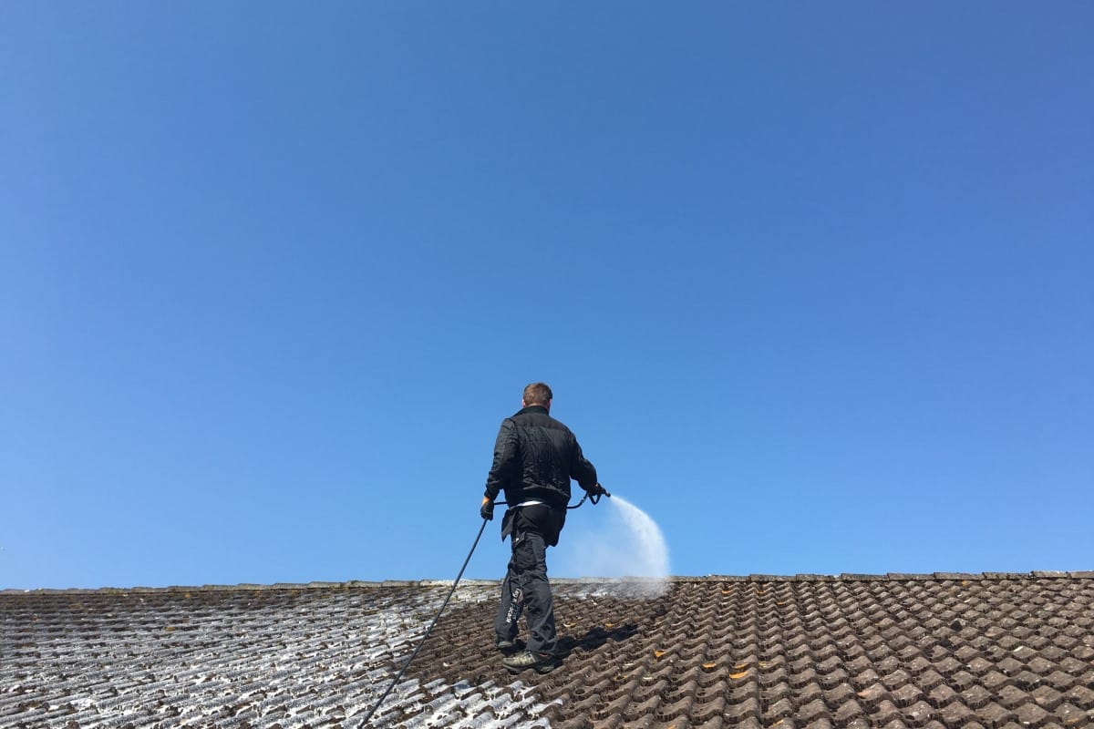 Man Cleaning Roof Man Cleaning Roof