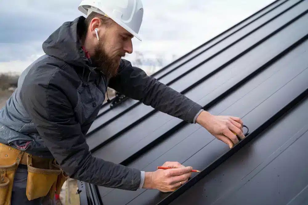 roofing contractor working with roof holding pencil wearing ear pods roofing contractor working with roof holding pencil wearing ear pods